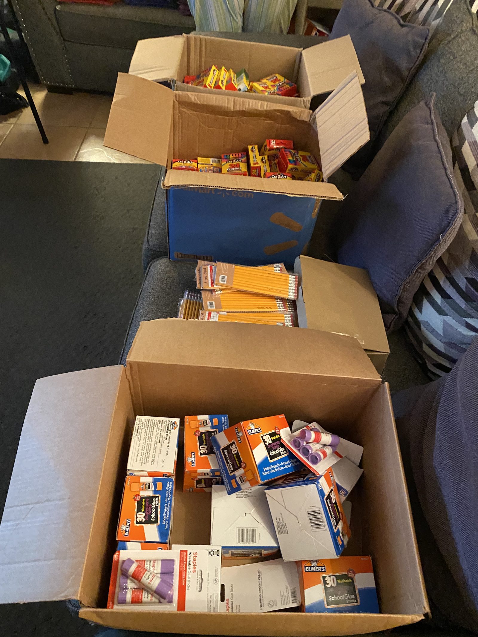 Boxes of crayons, pencils and glue sticks ready for the Back-to-School Bash