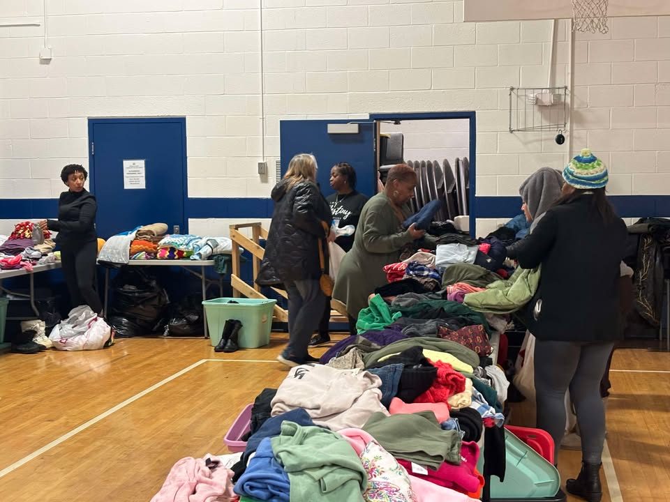 Neighbors choose donated clothing at a community giveaway