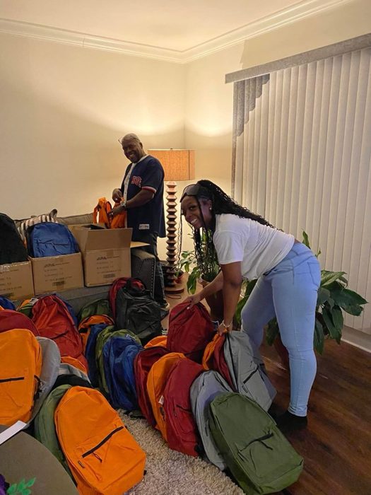 A volunteer with the packed backpacks.