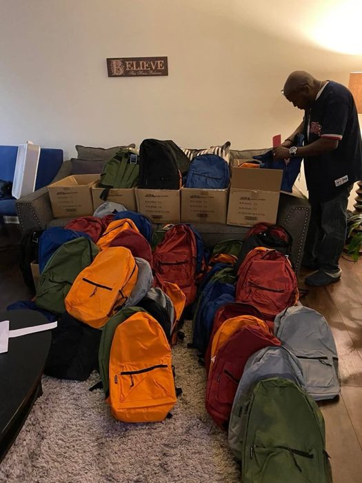 Dozens of backpacks lined up for giveaway.