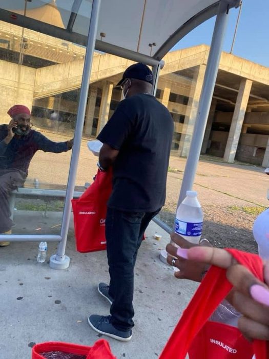 Serving a neighbor at the bus stop.