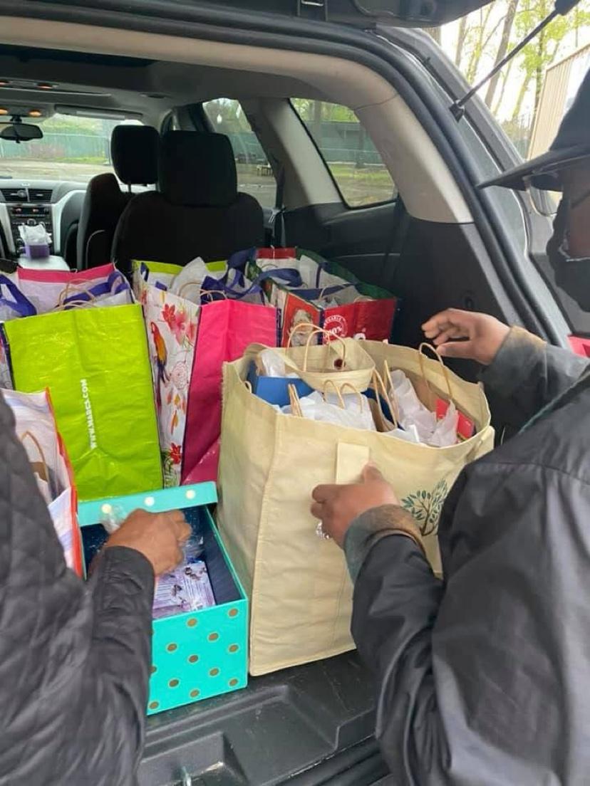 A car trunk packed with colorful gift bags