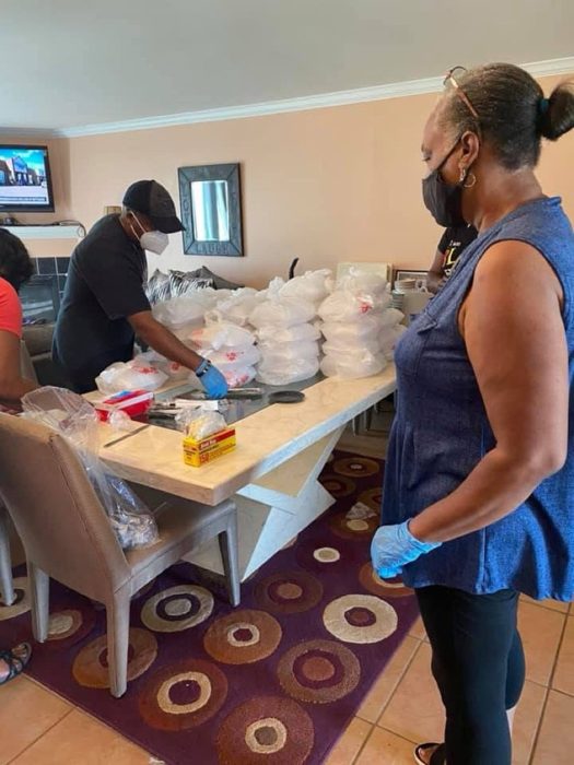 Volunteers stacking meals for street outreach.