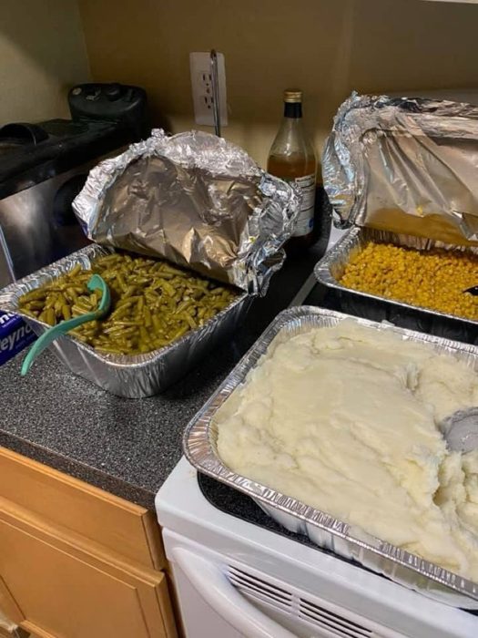 Home-cooked sides: green beans, corn, and mashed potatoes.