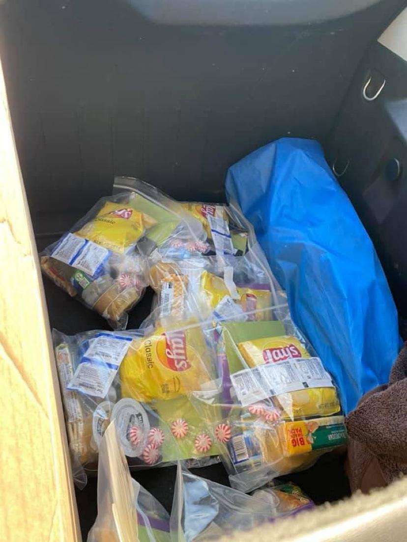Snack bags with chips and candy packed in a car trunk