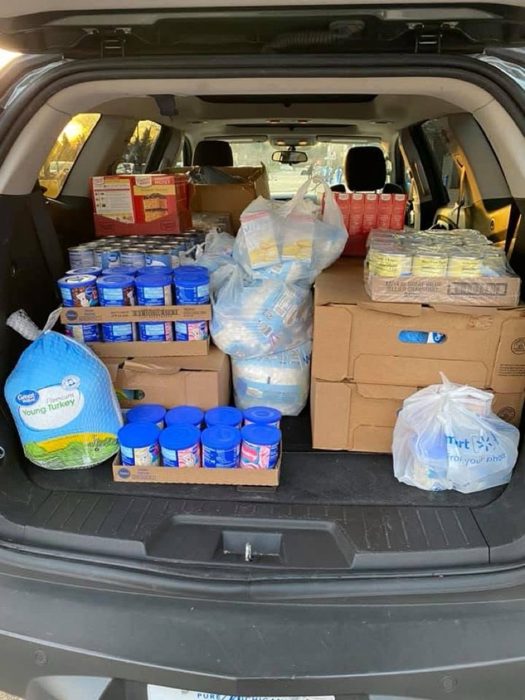 A trunk full of Thanksgiving: turkey, cans, and fixings.